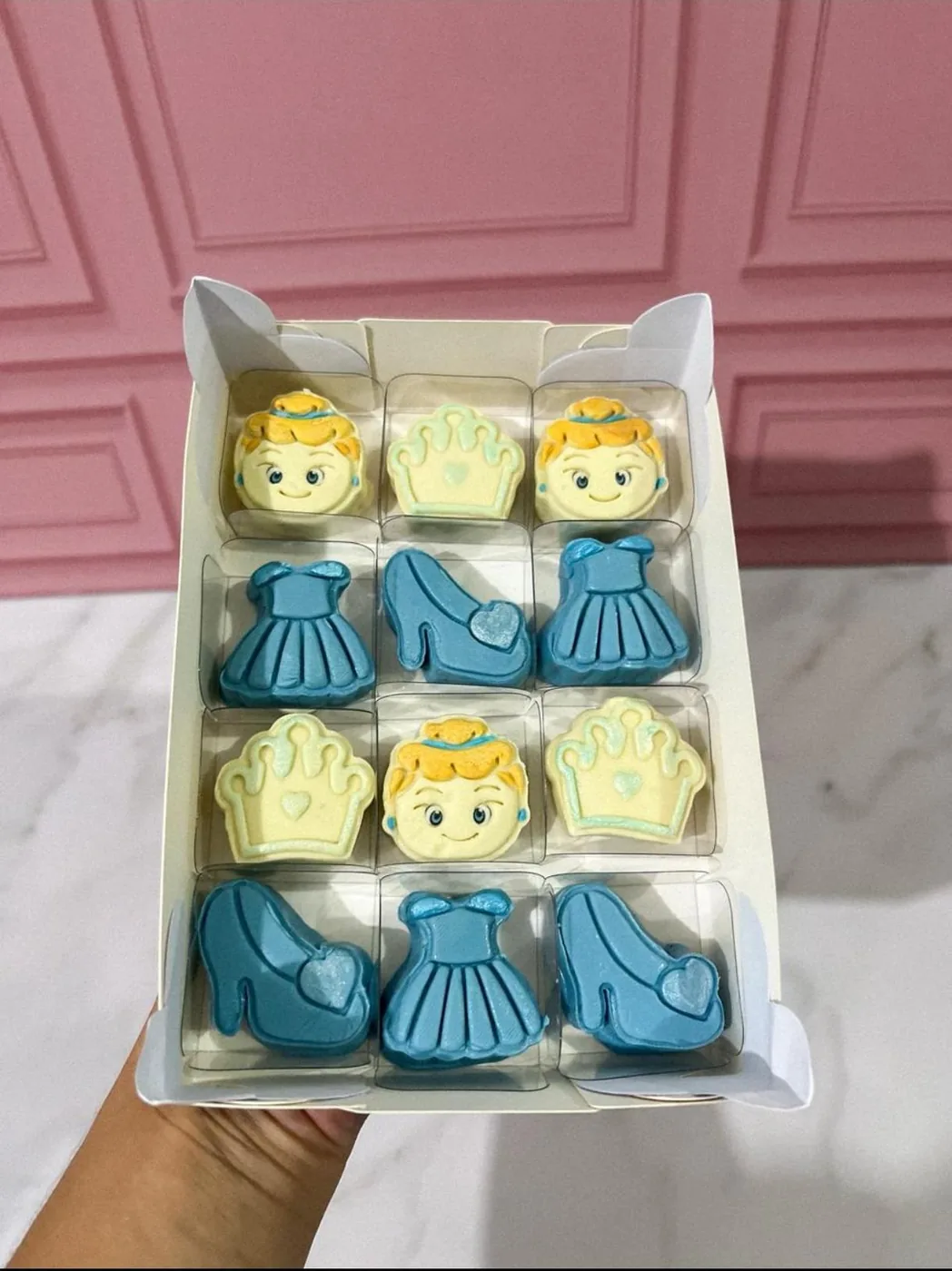Caixa com doces personalizados inspirados em princesa com coroa, vestido e sapatinho.